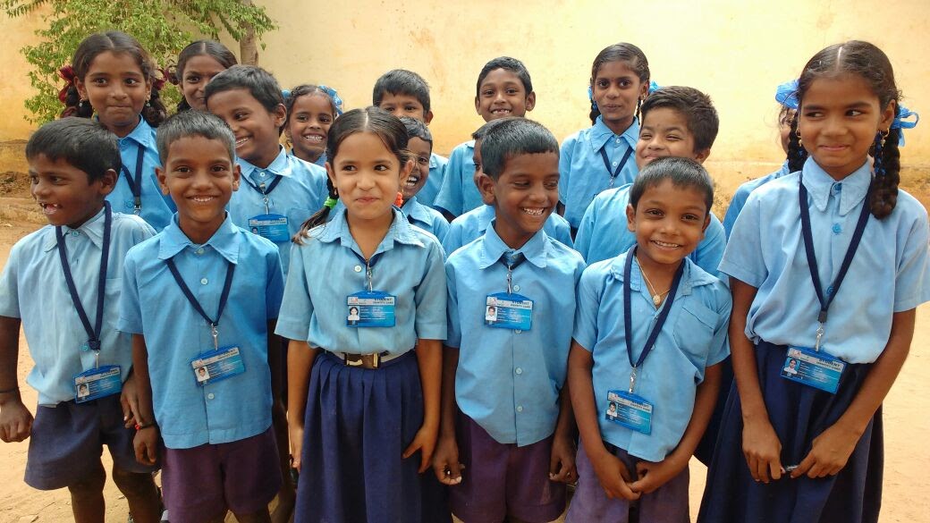Giggly school kids proudly wearing the Smart Attendance ID card