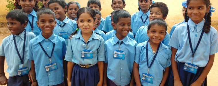 Giggly school kids proudly wearing the Smart Attendance ID card